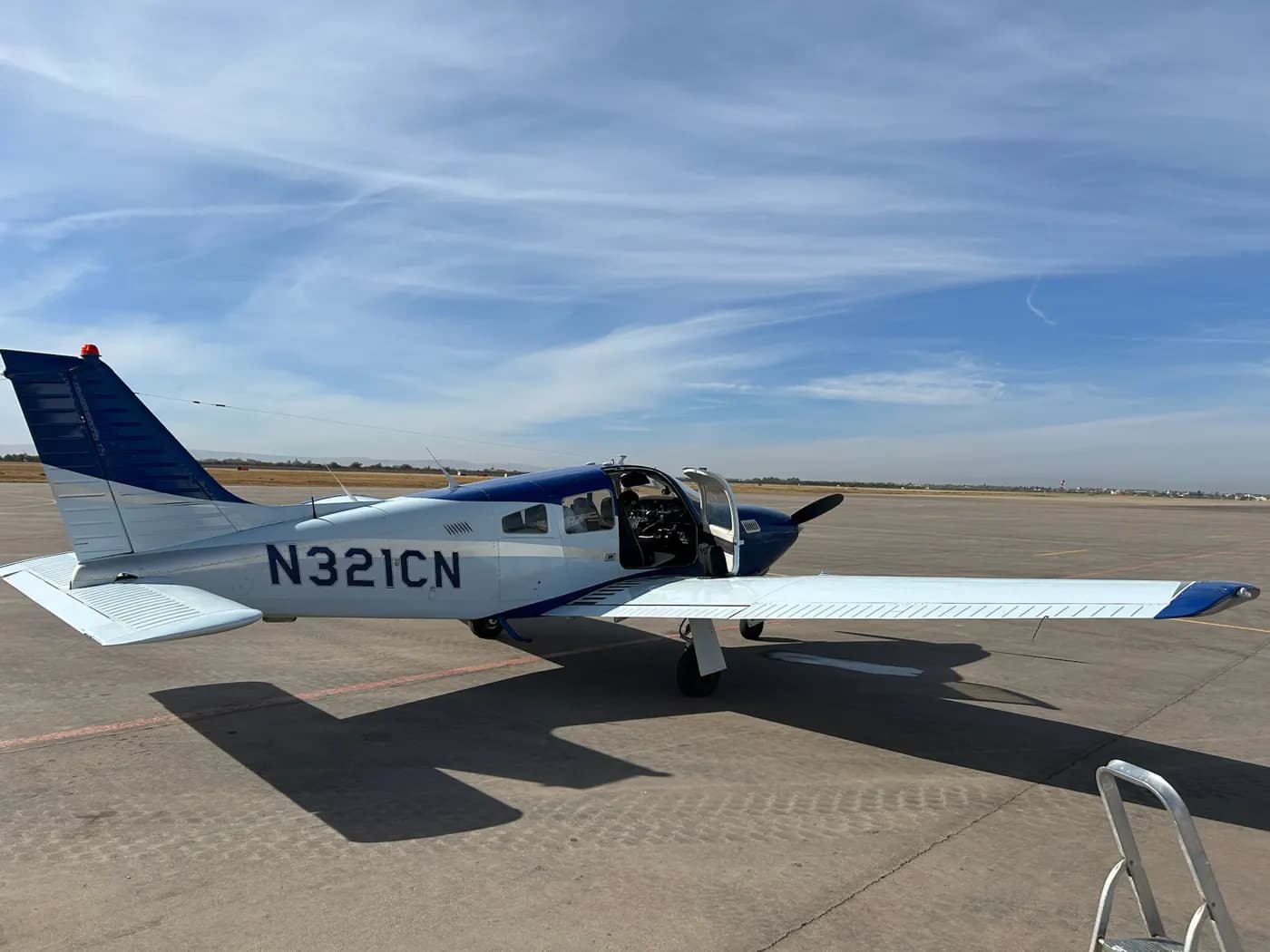 An N-registered low-wing aircraft on the ramp